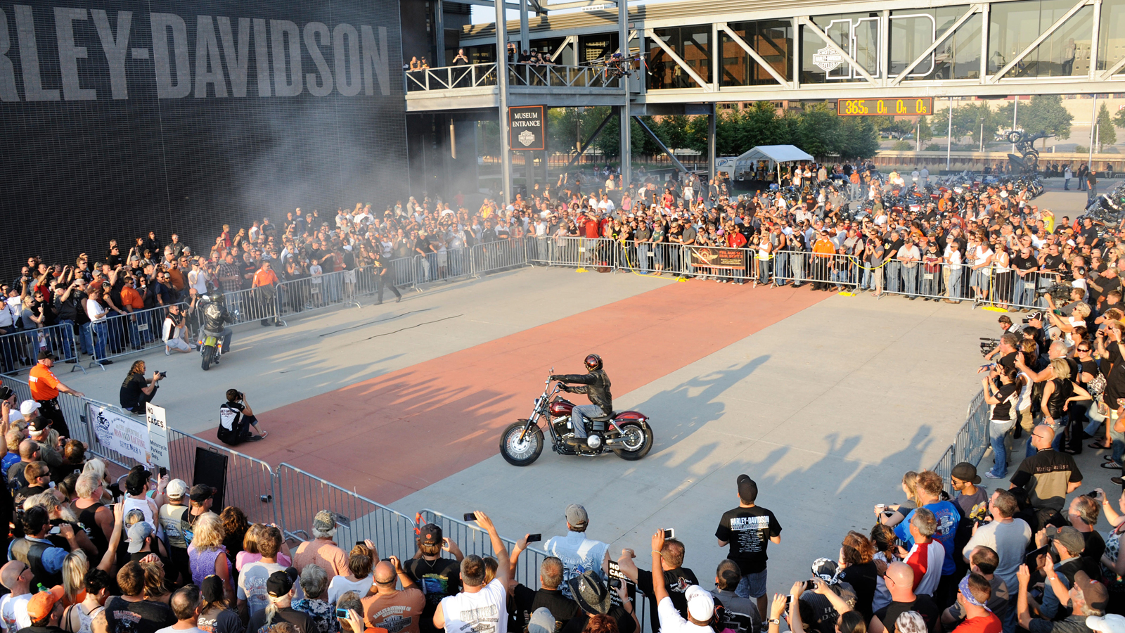 Stunt rider in front of crowd at the H-D Museum